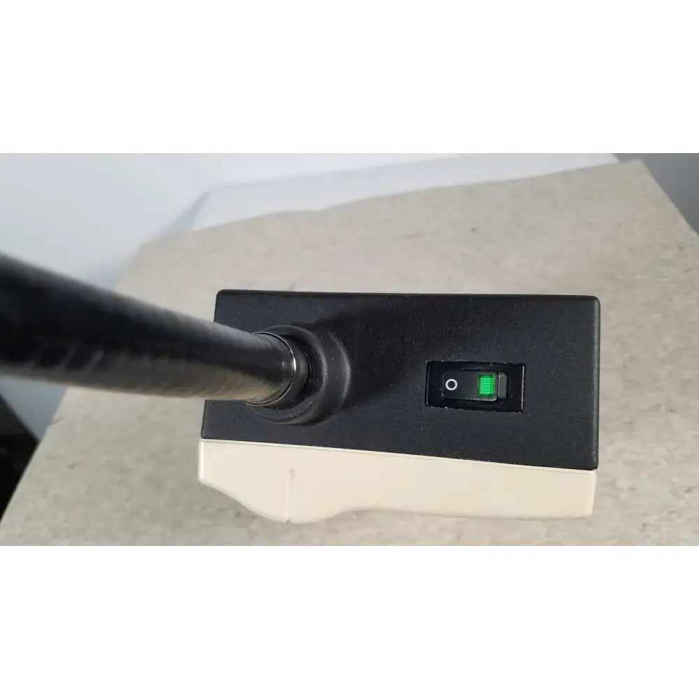 Black and beige welch allyn 48740 exam light with green illuminated switch and black cylindrical exam light neck attachment