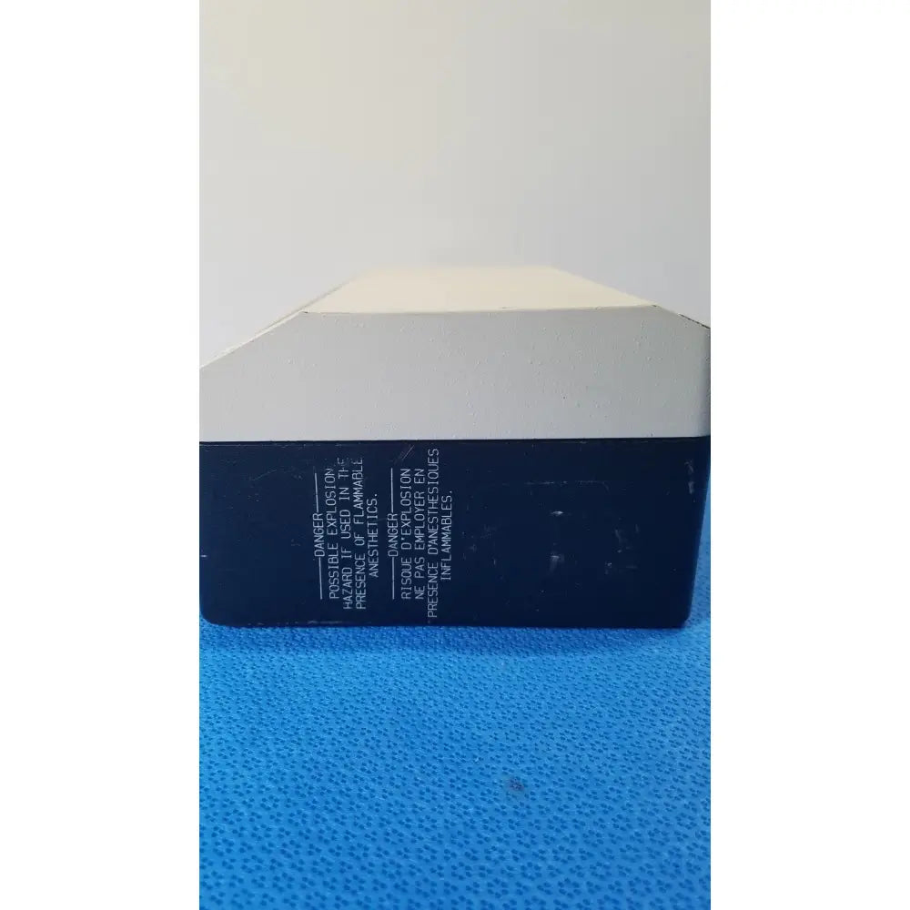 Black and white rectangular reuse medical lite box by welch allyn with warning labels in english and french on the back side