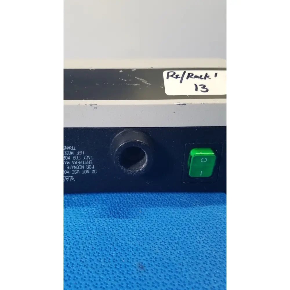 Welch allyn lite box black and gray electronic device with green power button and circular port labeled rsl rock 13 reuse medical