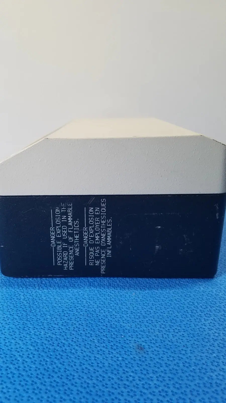 Black and white rectangular reuse medical lite box by welch allyn with warning labels in english and french on the back side