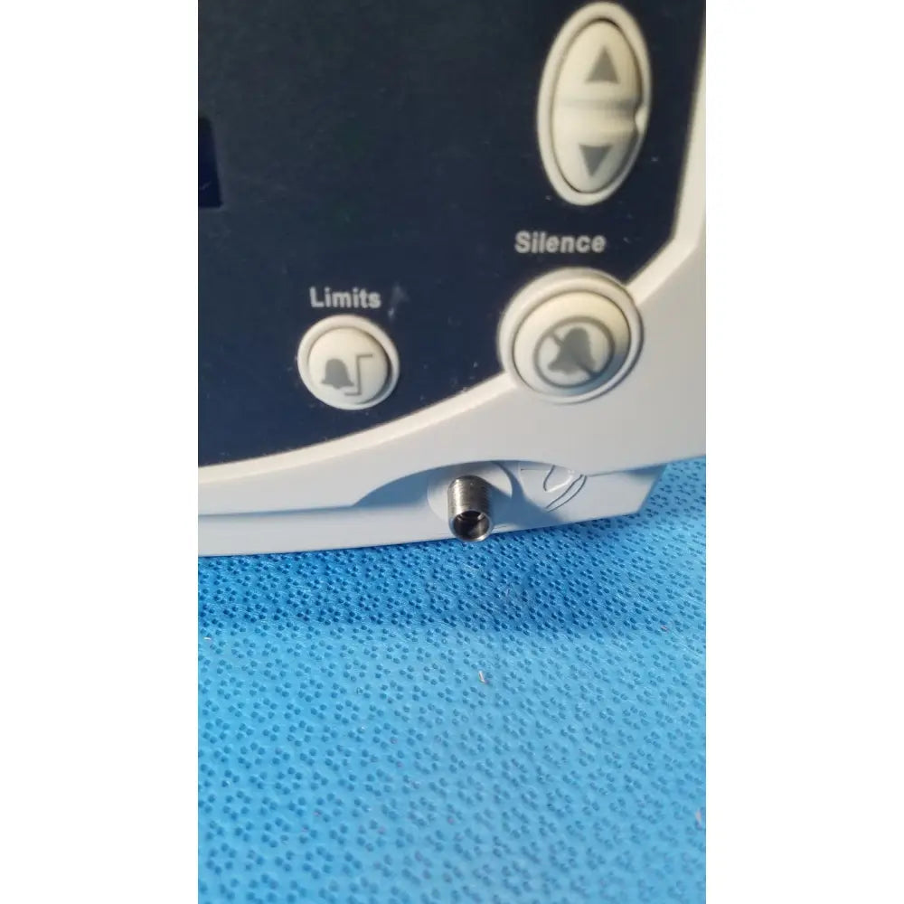 White and dark gray welch allyn 530t0 vital signs monitor with circular limits and silence buttons and a small metallic port below