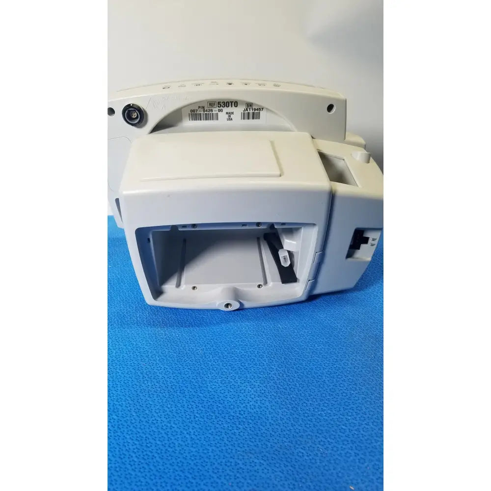 White plastic medical device with rectangular housing and open front compartment of welch allyn 530t0 vital signs monitor