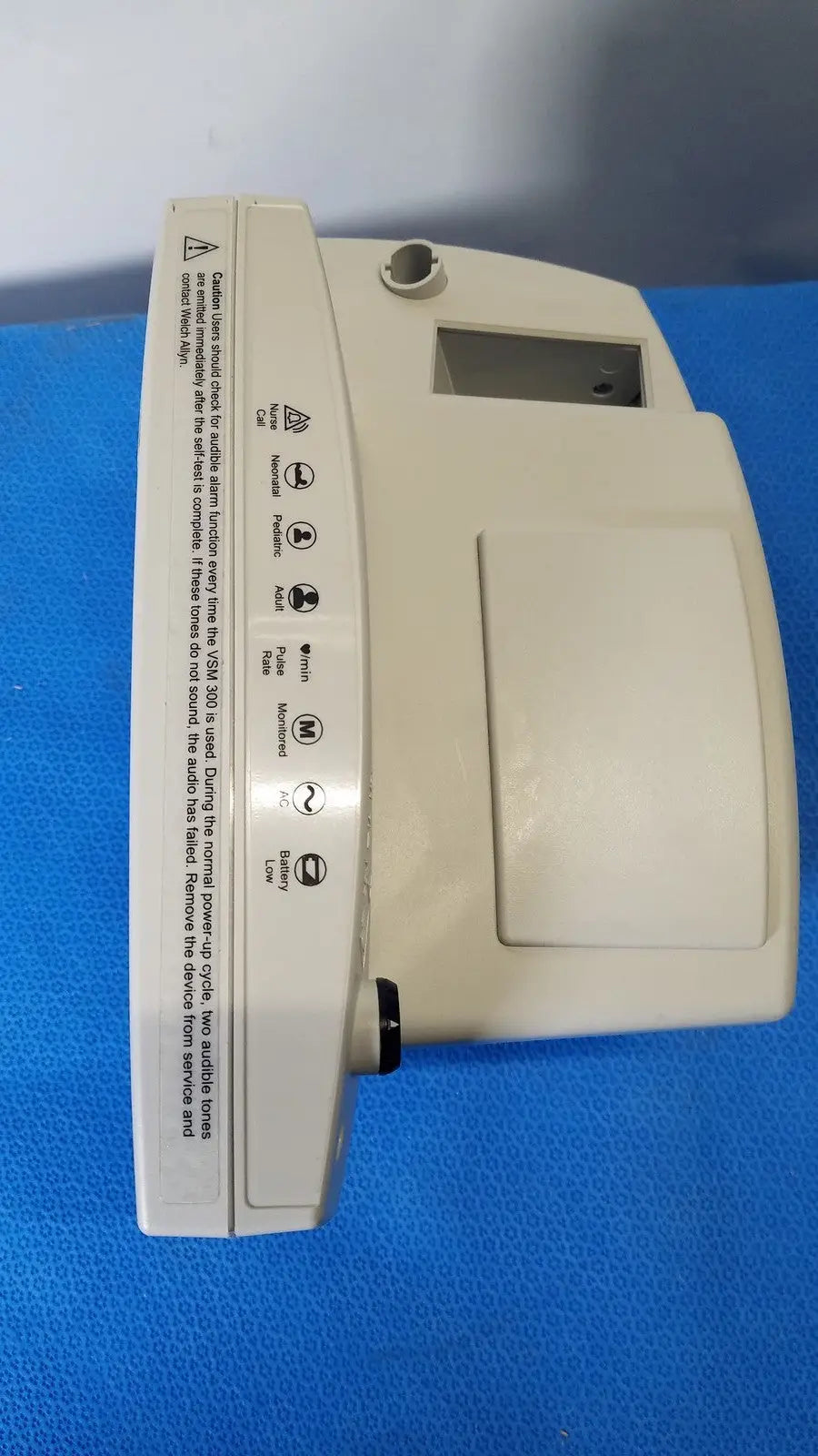 Beige plastic welch allyn 530t0 vital signs monitor with rectangular screen control buttons and warning labels on side