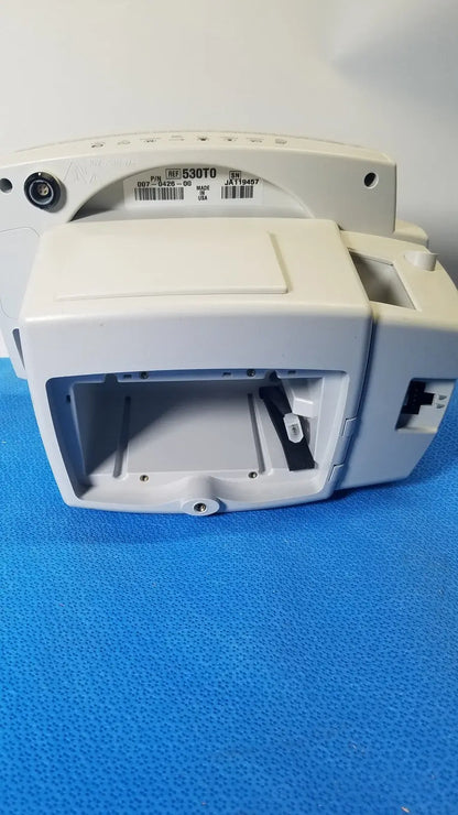White plastic medical device with rectangular housing and open front compartment of welch allyn 530t0 vital signs monitor