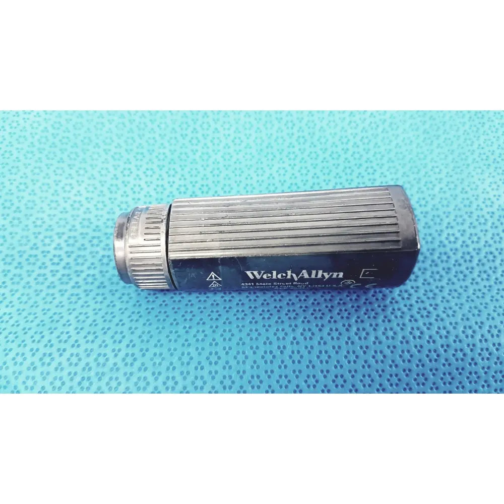 Welch Allyn 73211 rectal light handle with black and silver ribbed texture and threaded end for medical examination illumination