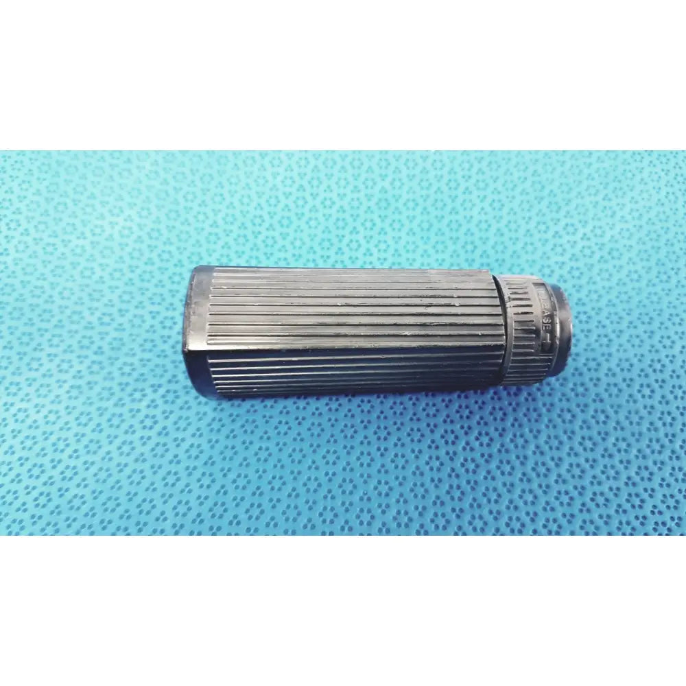 Black ribbed cylindrical rectal light handle with textured grip and engraved markings for medical use by welch allyn