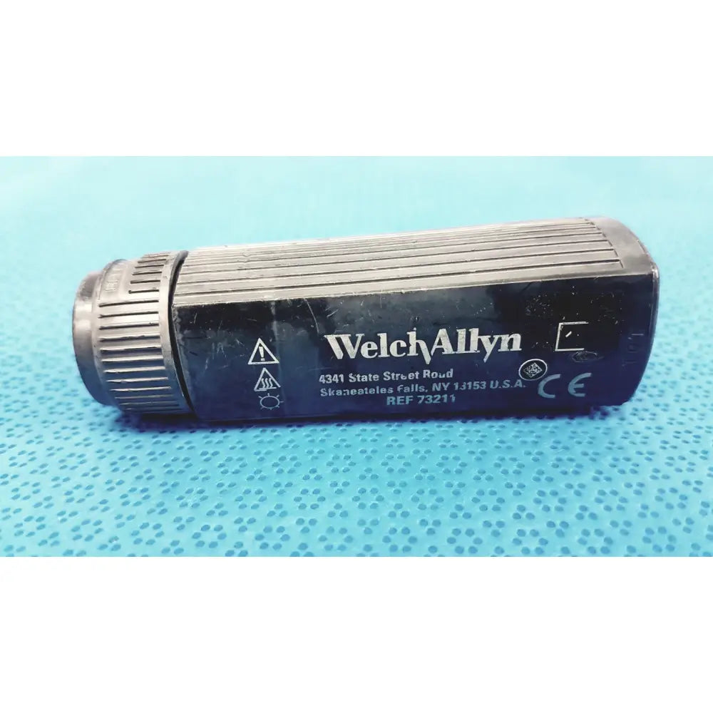 Black welch allyn 73211 rectal light handle with ribbed texture and metallic threaded cap for medical illumination