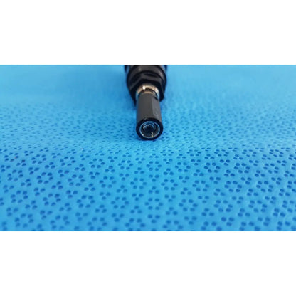 Black cylindrical end of medical endoscope lens shown on the back side of welch allyn 73305 6V power adapter plug
