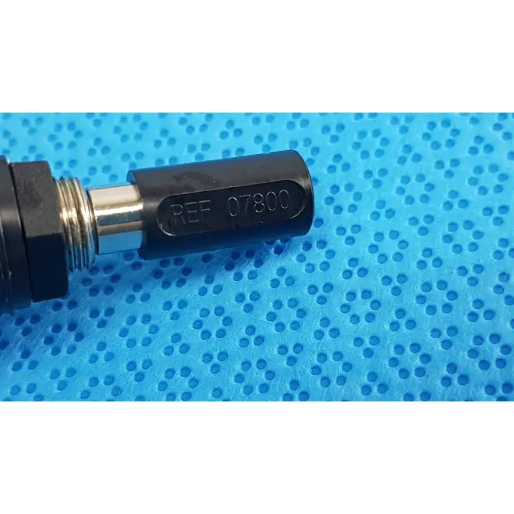 Black cylindrical welch allyn power adapter plug with engraved ref 07800 and metallic threaded section for medical use