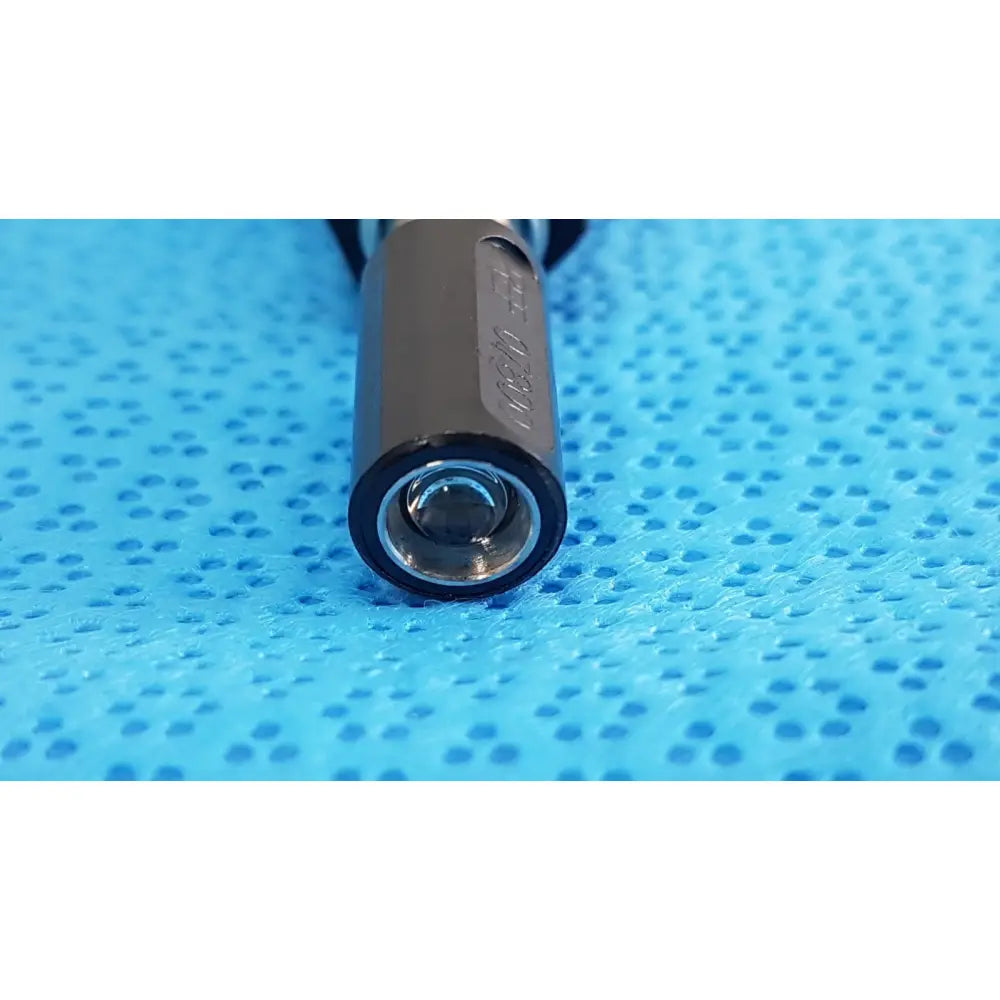 Welch Allyn 73305 gray metallic cylindrical power adapter plug with black rubber grip and engraved markings for medical devices