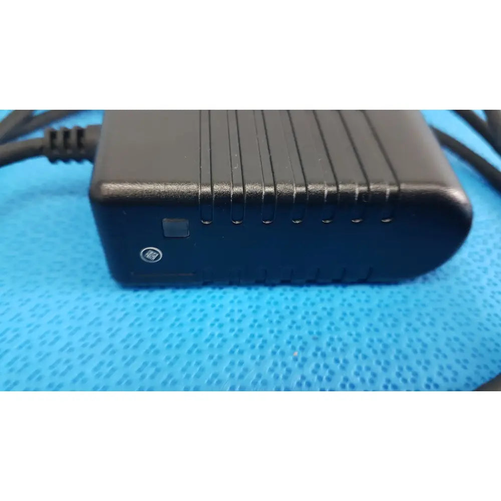 Black welch allyn 73305 6v power adapter plug with textured ribbed surface and integrated ventilation slots for medical devices