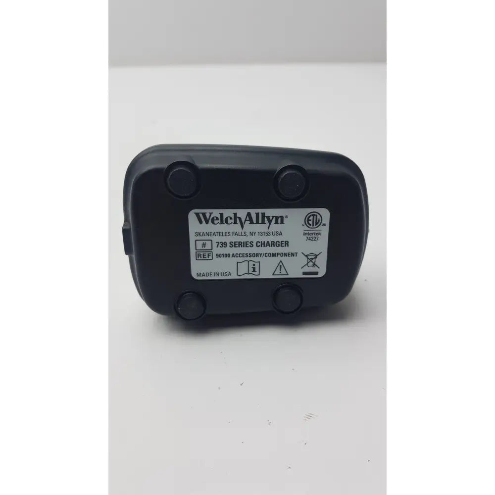 Black plastic welch allyn 739 series charger with white label showing model and certification for reuse medical use