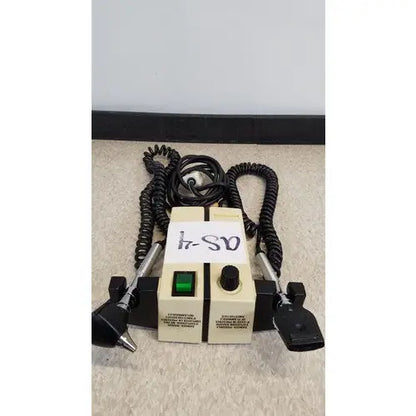 Beige welch allyn transformer otoscope ophthalmoscope with black coiled cords and two metal probes attached