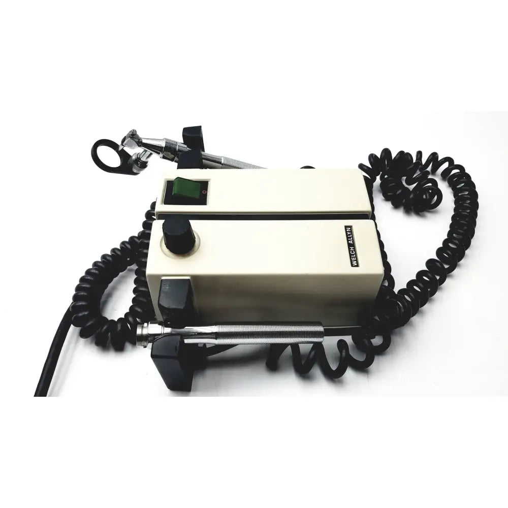 Cream-colored Welch Allyn 74710 wall transformer ophthalmoscope otoscope with black coiled cords and metallic attachments