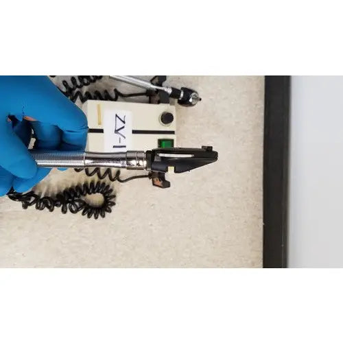 Silver and black welch allyn 74710 wall transformer with coiled cord labeled zaz-1 for reuse medical applications