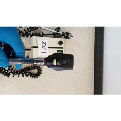 Black and silver welch allyn otoscope with coiled cord compatible with 74710 wall transformer for reuse medical use