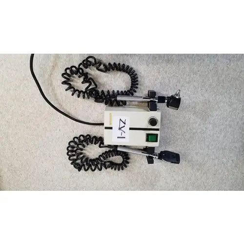 Welch allyn white medical otoscope with black coiled cords and green power button for wall transformer reuse medical use