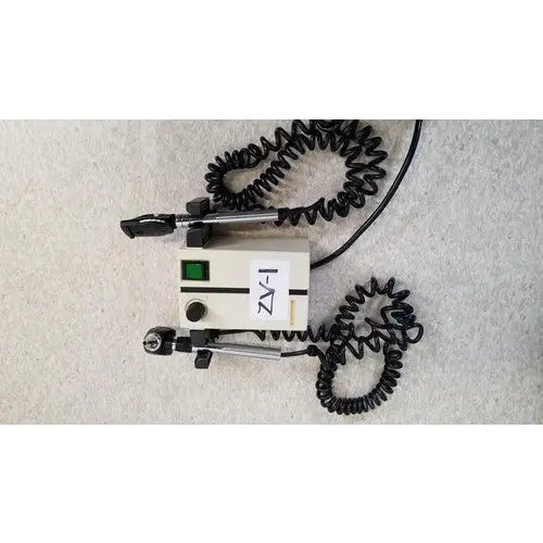 Beige welch allyn 74710 wall transformer with black coiled cords and green power indicator light for reuse medical devices