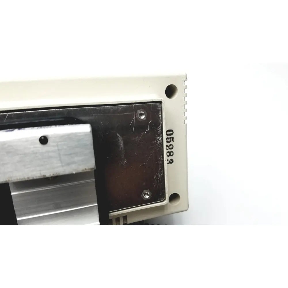 Beige plastic housing with black metal panel and engraved serial number 05283 on the back of welch allyn series transformer otoscope