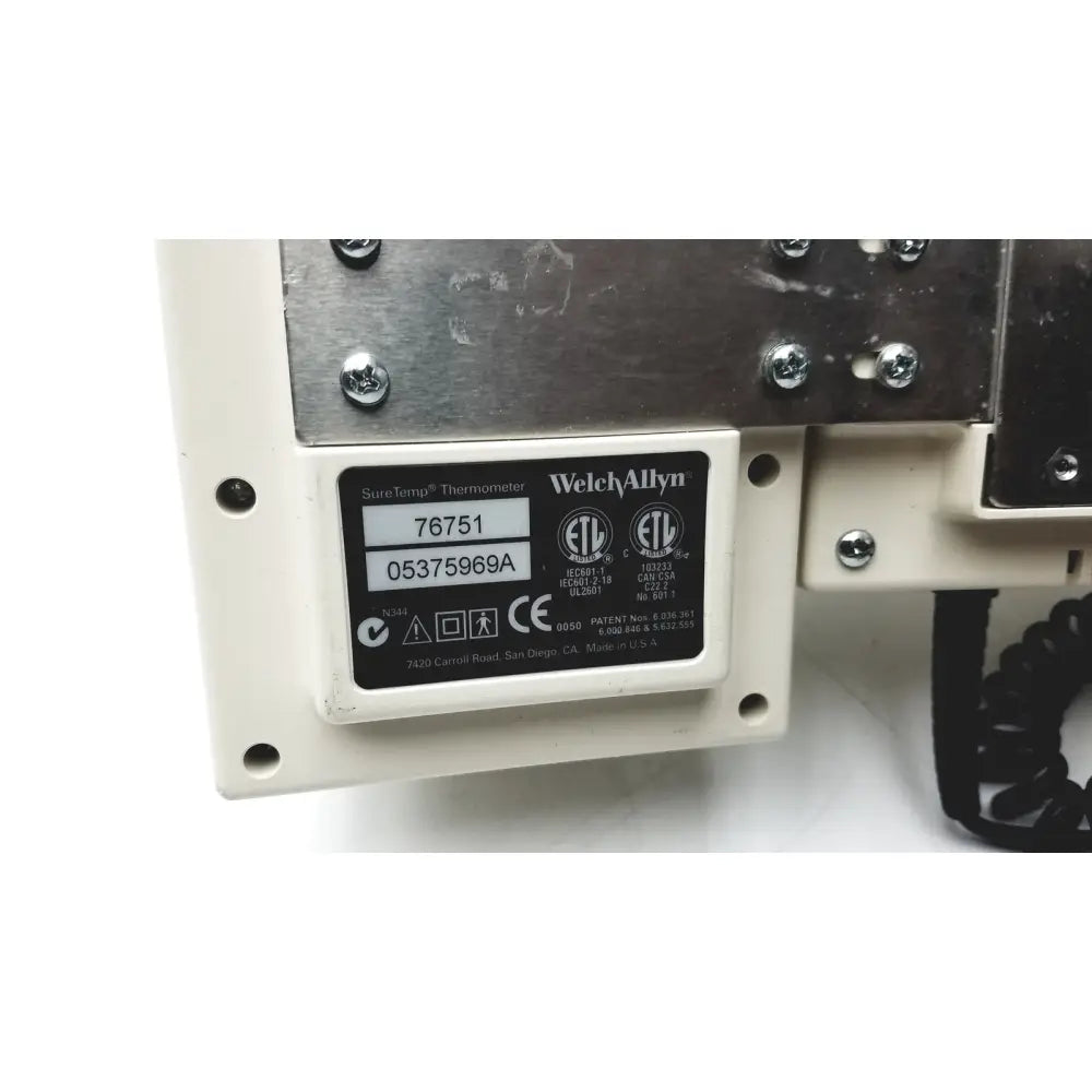 White plastic label with black text and logos for welch allyn suretemp thermometer on the back of series transformer otoscope