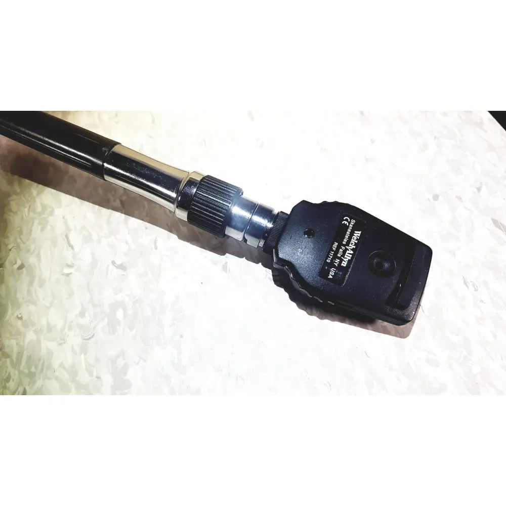 Black handheld welch allyn series transformer otoscope with metallic joint textured grip for diagnostic wall transformer use