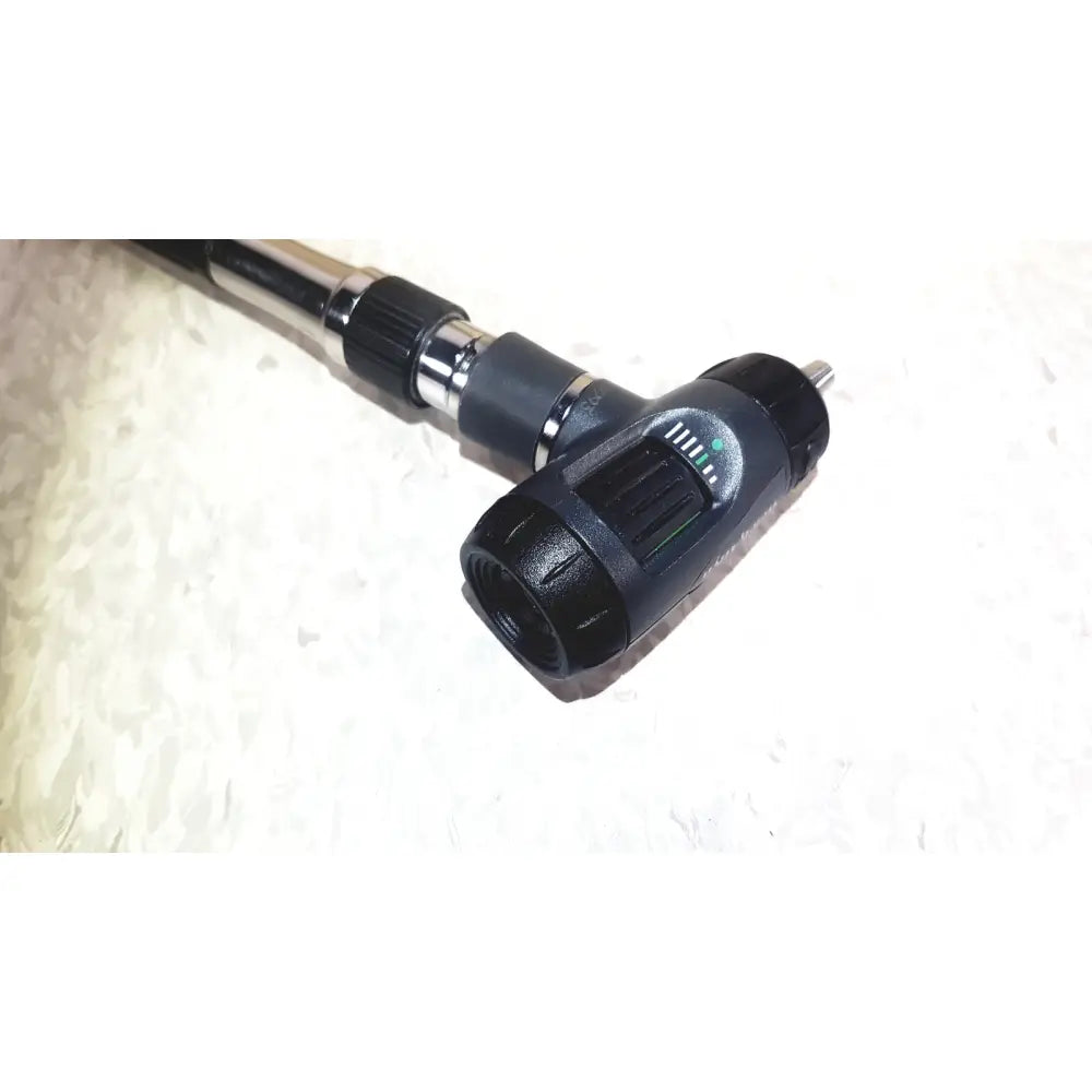 Black and silver welch allyn 767 series transformer with heads featuring a textured grip and adjustable light diagnostic wall transformer