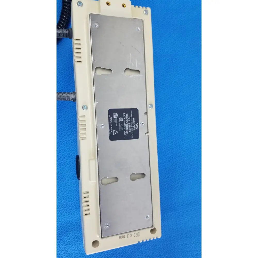 Beige plastic welch allyn 767 series transformer with silver metal plate and black label for reuse medical use