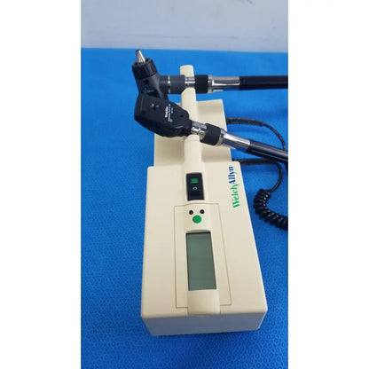 Welch allyn 767 series transformer with black and silver articulated arms otoscope and ophthalmoscope on cream base unit