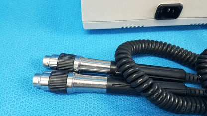 Welch allyn 767 series wall-mounted diagnostic power transformer with black and silver coiled cable and textured grip handles