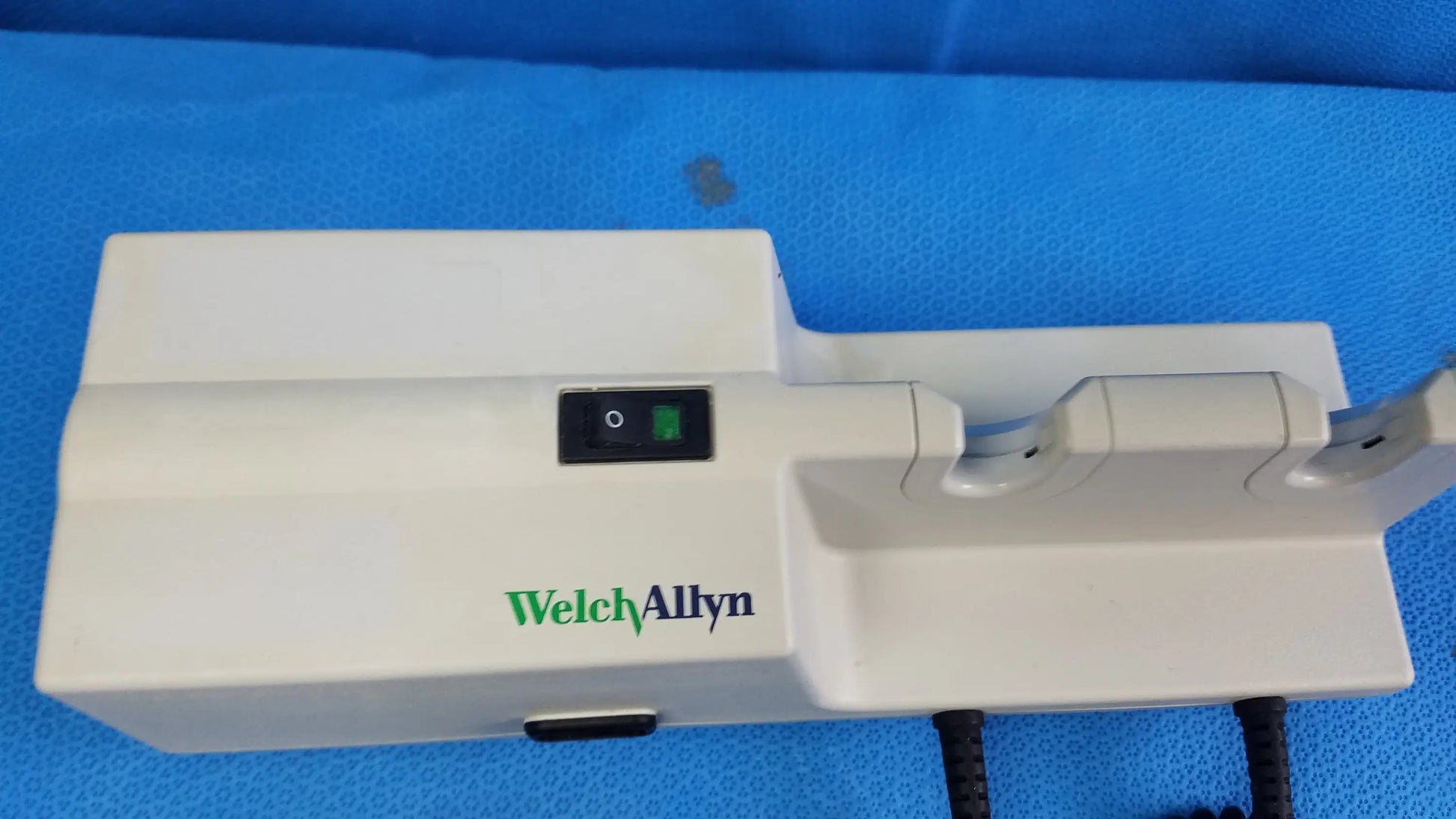 Welch Allyn 767 series wall-mounted diagnostic power transformer in white with green and black branding and two instrument slots