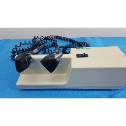 White medical otoscope with black and silver attachments and coiled cord for welch allyn 767 series wall transformer