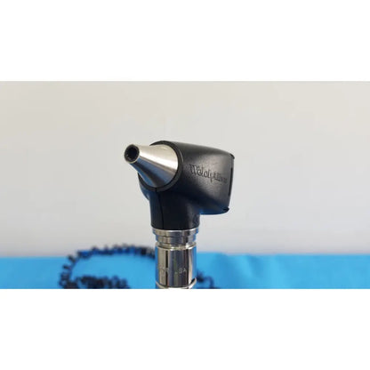 Black and silver welch allyn otoscope with metallic tip and ergonomic handle for 767 series wall transformer use