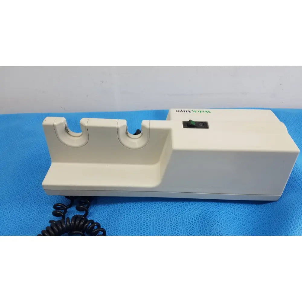 Cream-colored plastic electric knife sharpener with two slots and black switch for welch allyn series wall transformer use