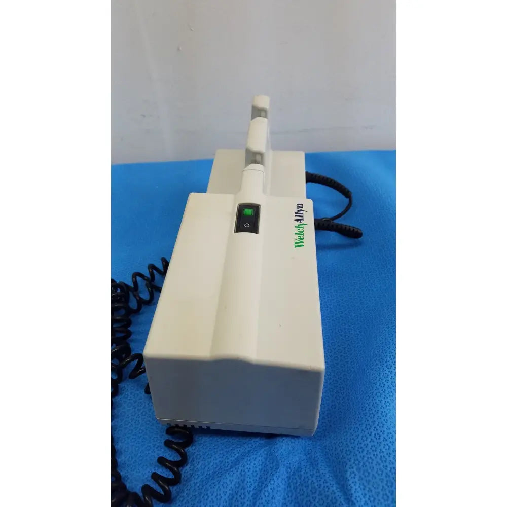 Welch allyn 767 series wall transformer with panoptic ophthalmoscope featuring white body green power indicator and black cord