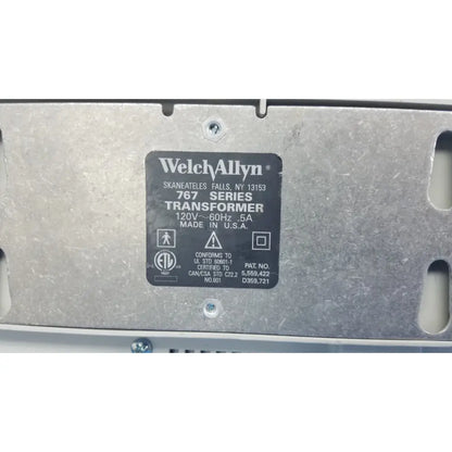 Black rectangular label on metallic surface identifying the welch allyn 767 series wall transformer for medical use