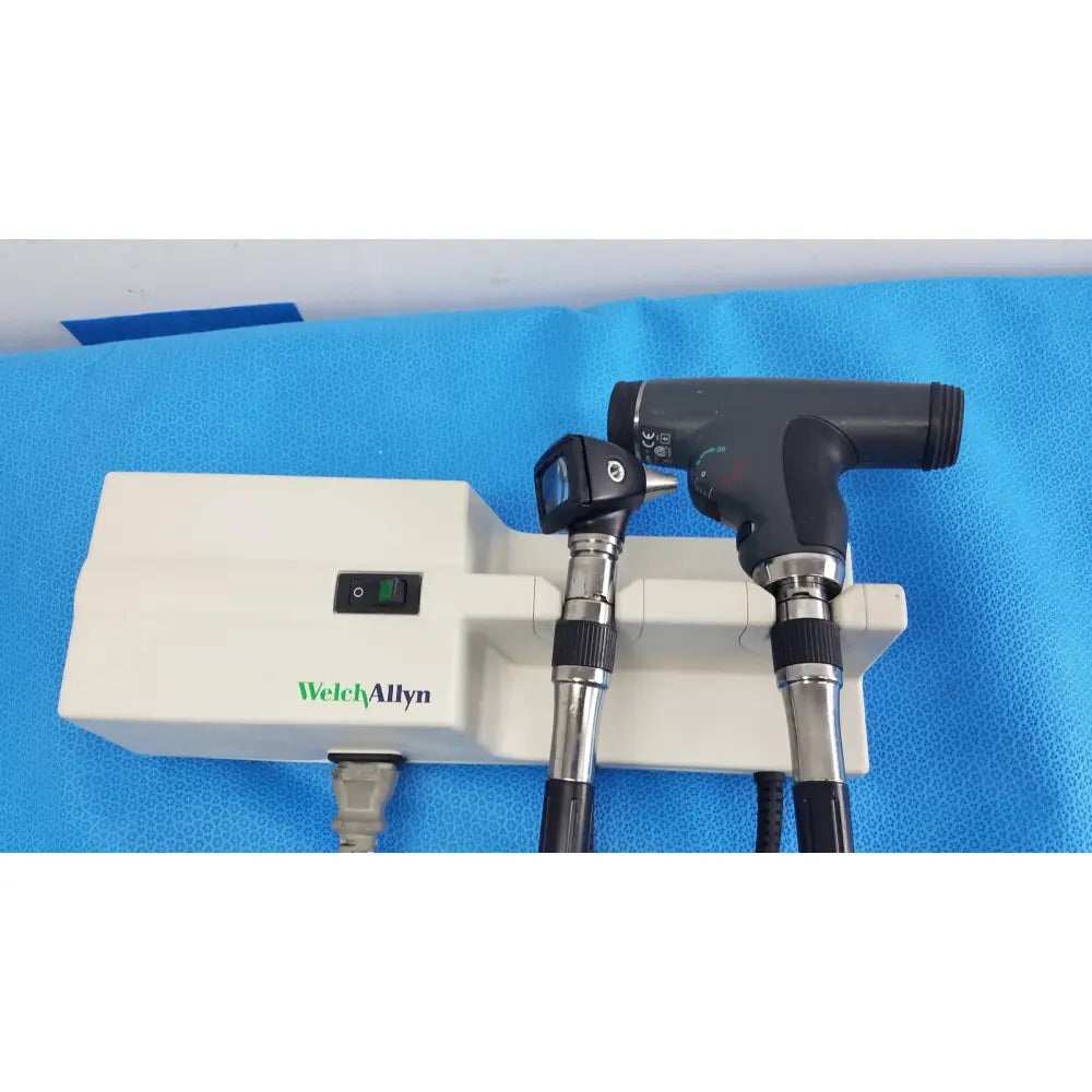 Welch Allyn 767 series wall transformer with PanOptic otoscope and surgical light unit with black handles and white base