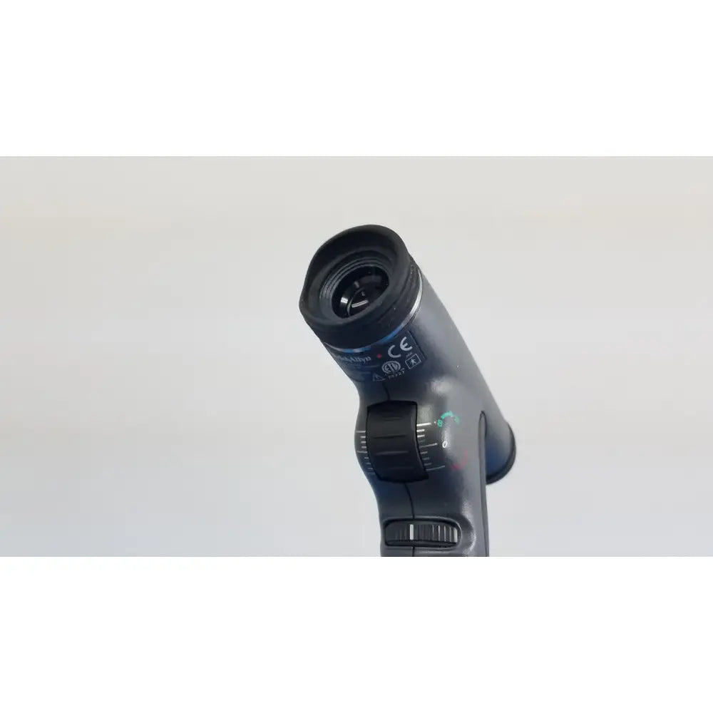 Black handheld otoscope with textured grip and adjustable focus dial from welch allyn 767 series wall transformer