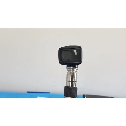 Black digital otoscope with rectangular screen and metallic segmented shaft from welch allyn 767 series wall transformer