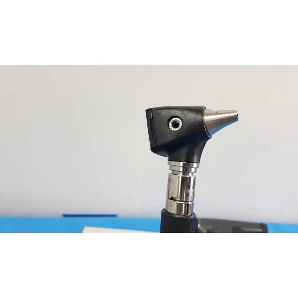 Black and silver welch allyn panoptic otoscope with matte black handle and chrome tip in 767 series wall transformer