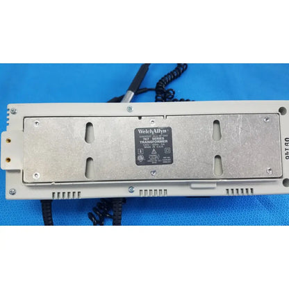 White plastic housing with silver metal plate showing welch allyn 767 series wall transformer label for reuse medical use