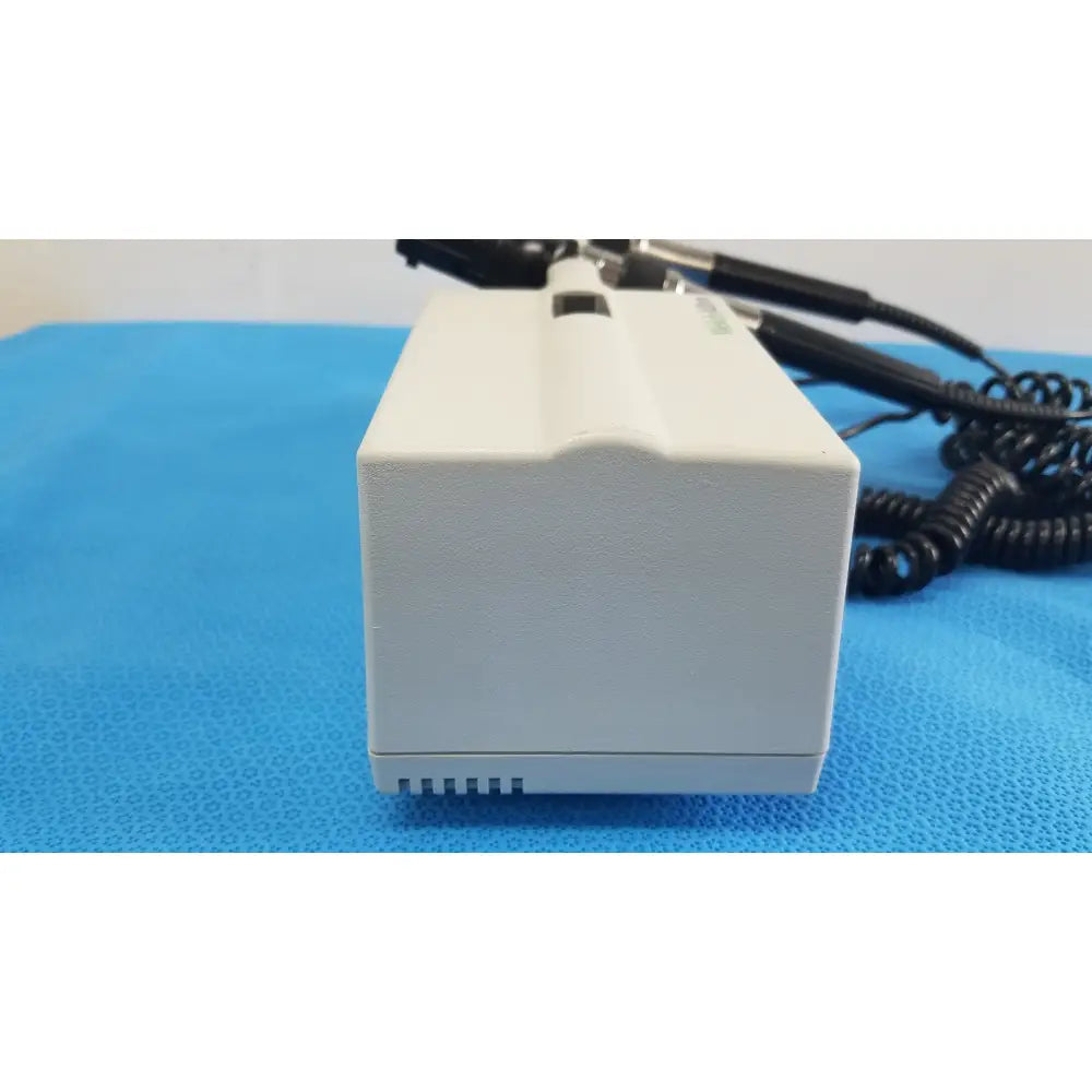 Welch allyn white rectangular wall transformer with black coiled cables and small slot for reuse medical devices