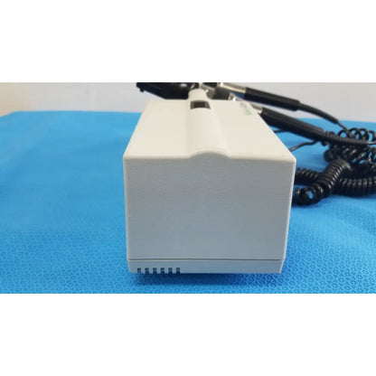 Welch allyn white rectangular wall transformer with black coiled cables and small slot for reuse medical devices