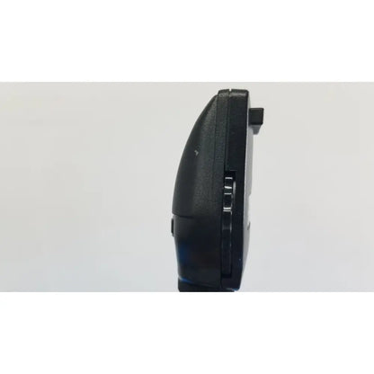 Black plastic nintendo ds handheld gaming console with matte finish and hinge mechanism beside welch allyn wall transformer reuse medical device