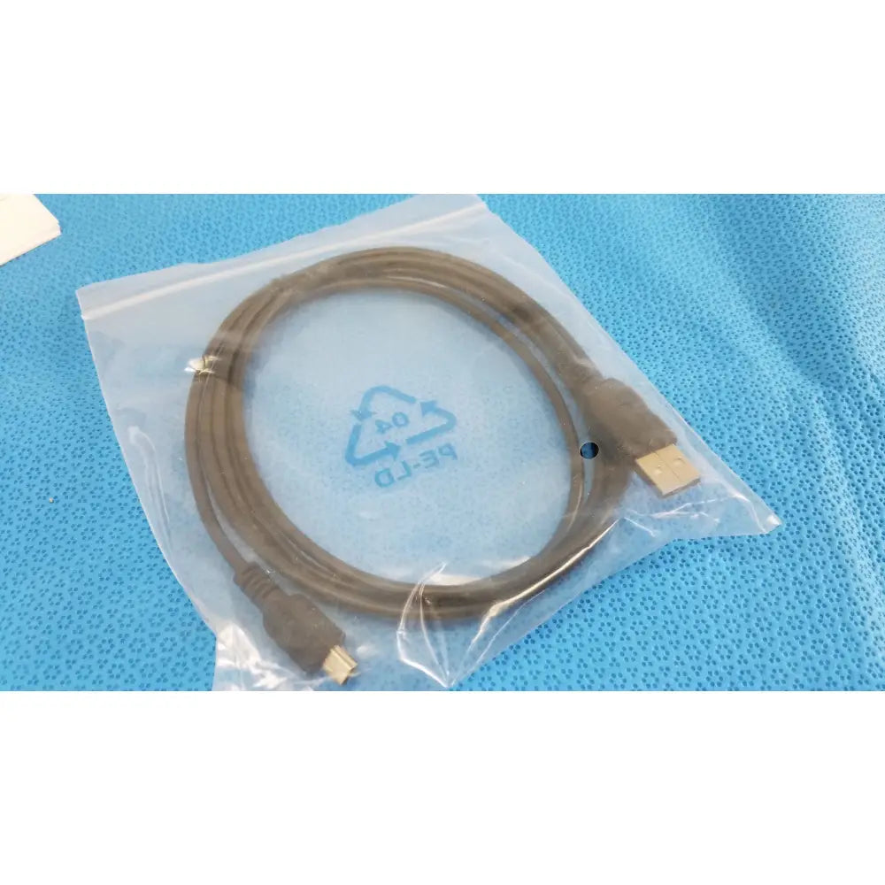 Brown usb cable with usb-a and mini-usb-b connectors coiled in a bag for welch allyn kleenspec cordless led system