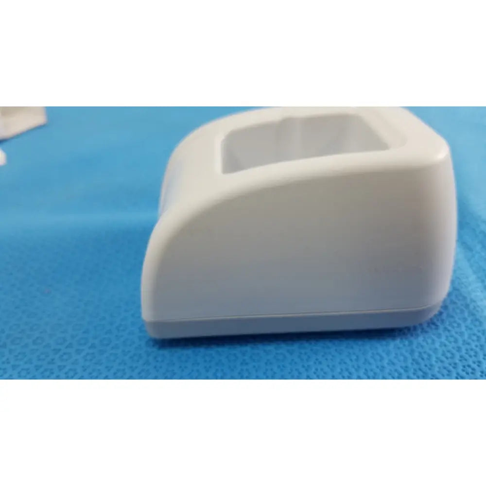 White plastic tissue box with rectangular opening and rounded edges in the welch allyn kleenspec cordless led system setup