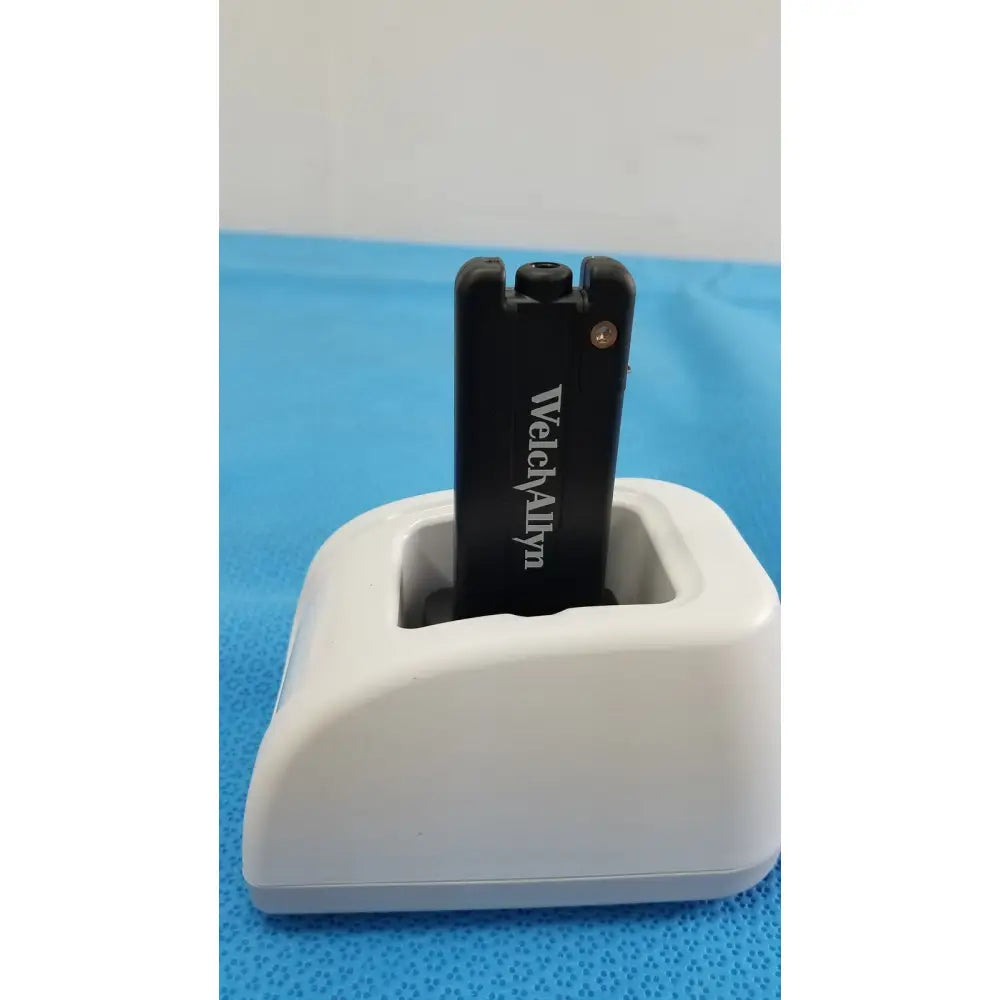 Black welch allyn usb flash drive resting in white charging dock for kleenspec cordless led illumination system