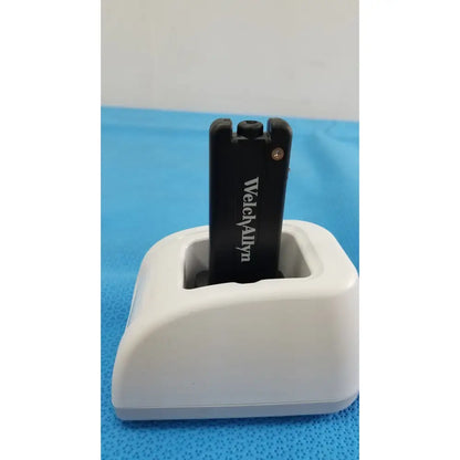 Black welch allyn usb flash drive resting in white charging dock for kleenspec cordless led illumination system