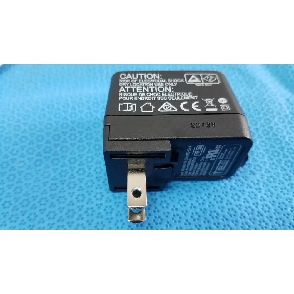 Black plastic usb wall charger with silver metal plug and labels for welch allyn kleenspec cordless led illumination system