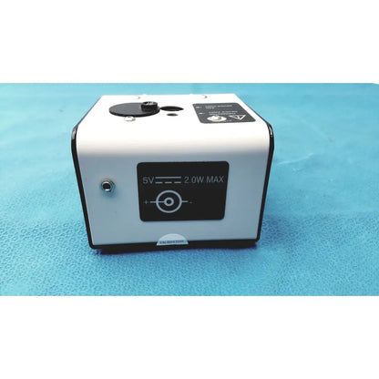 White rectangular welch allyn 9600 plus calibration tester laser pointer with black accents and 5v 2.0w max label