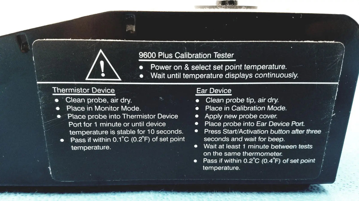 Black plastic welch allyn 9600 plus calibration tester with white printed instructions and warning label visible